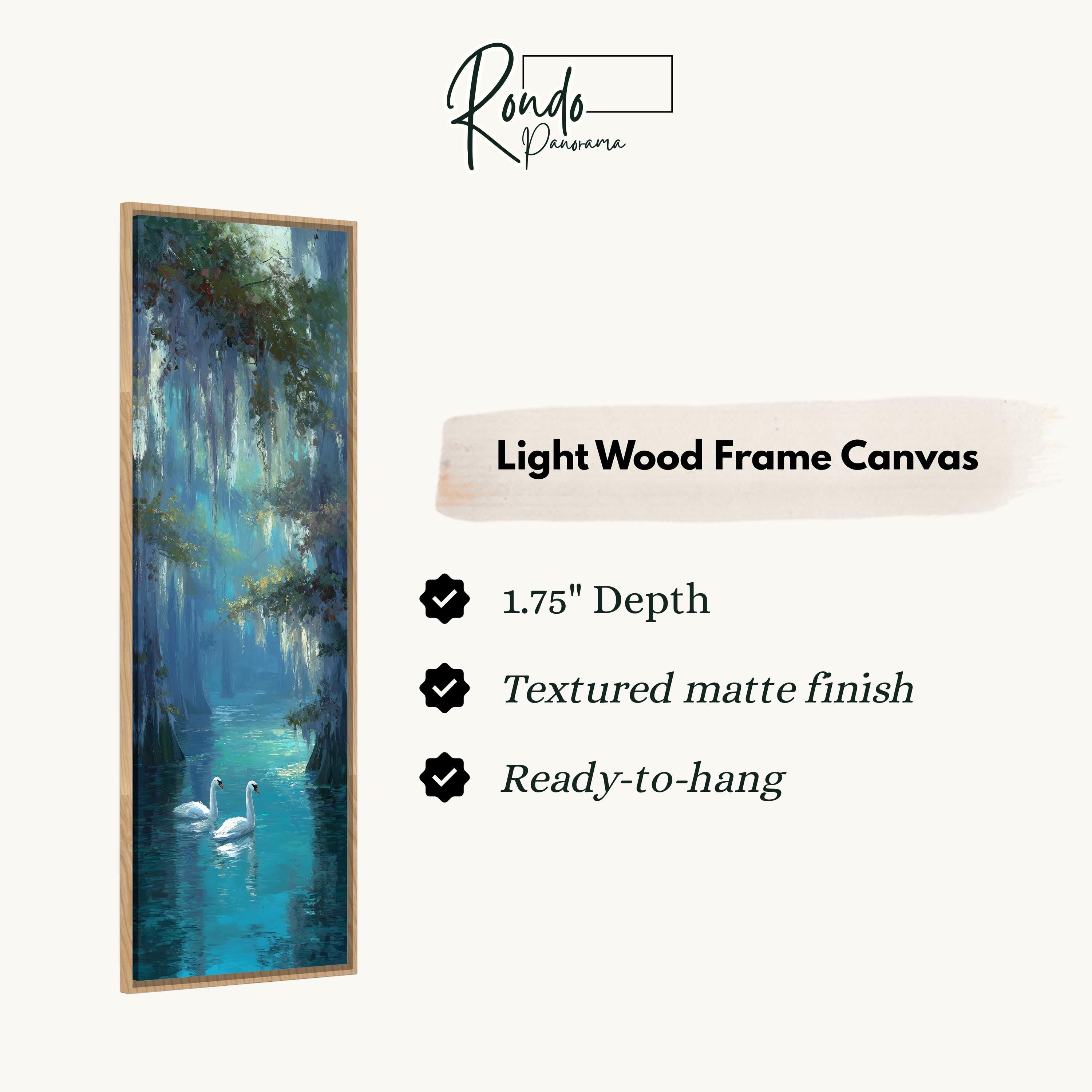 The image is a painting of two swans floating on a body of water, surrounded by lush greenery. The painting is framed in a light wood frame and is described as a "Light Wood Frame Canvas" with a depth of 1.75" and a textured matte finish. The painting is ready to hang.