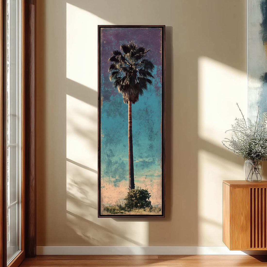 a framed painting of a palm tree hanging on a wall.