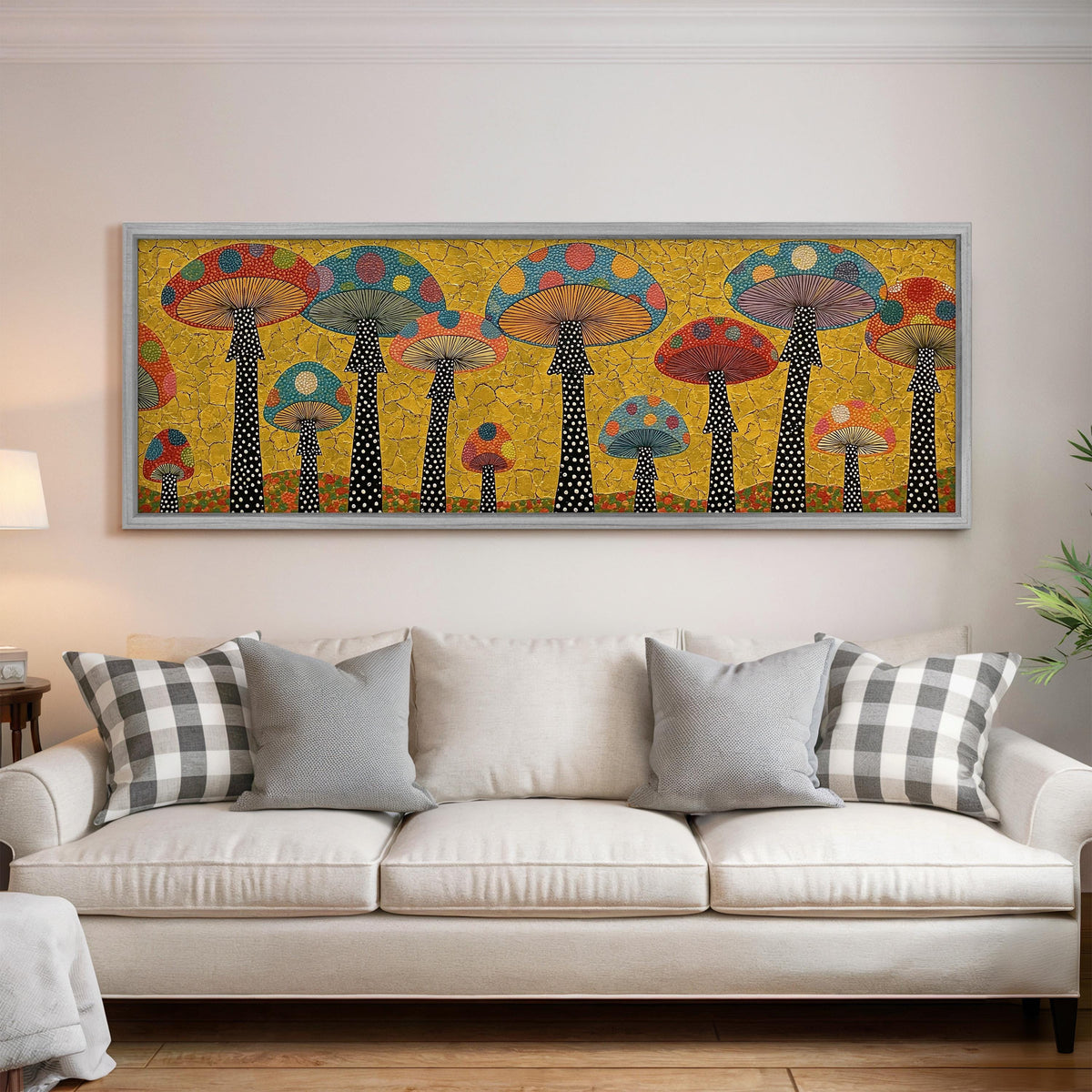 Polka dot mushrooms on gold panoramic canvas print above a white sofa in a bright living room