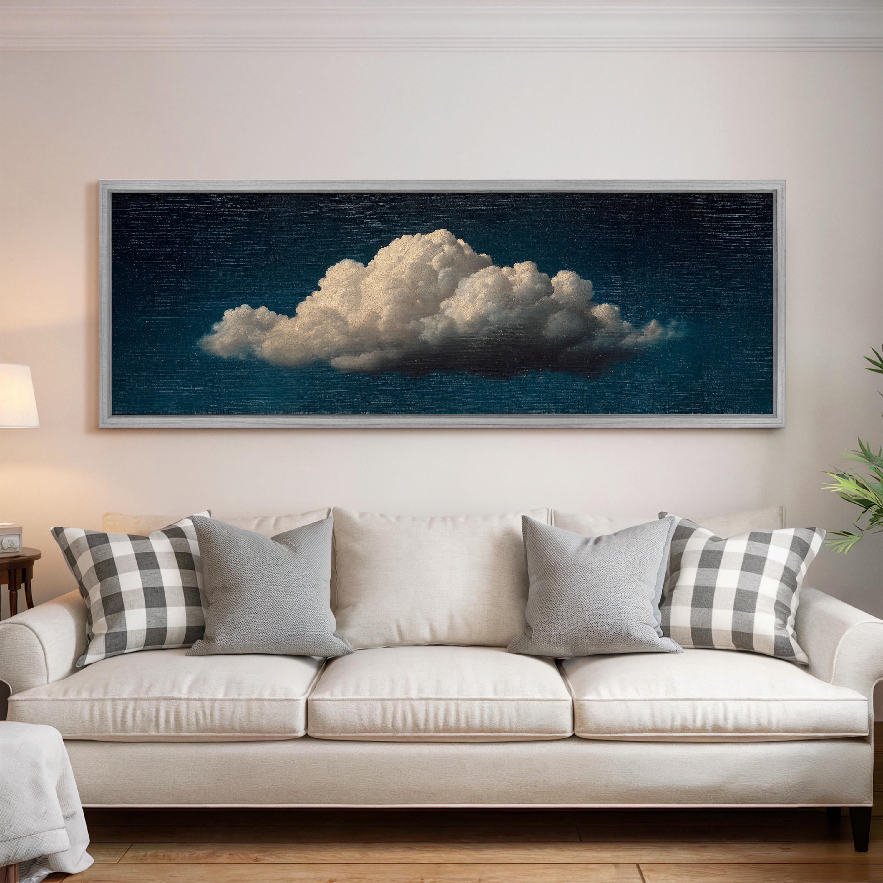 a large, framed painting of a cloud hanging on a wall above a white couch with gray and white plaid throw pillows.