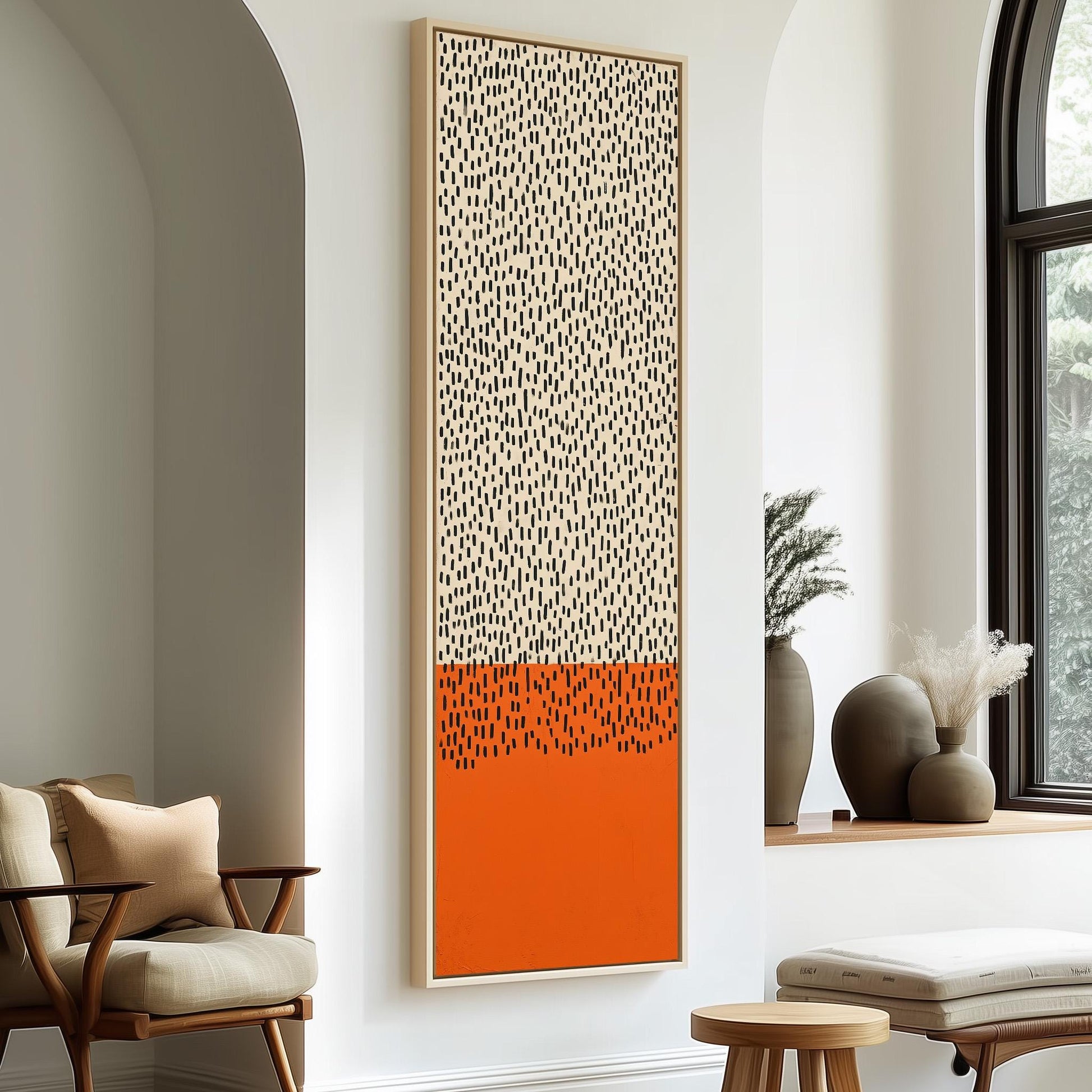 a modern living room with a large abstract painting hanging on the wall, a wooden chair, a small table, and a window with a plant on the sill.