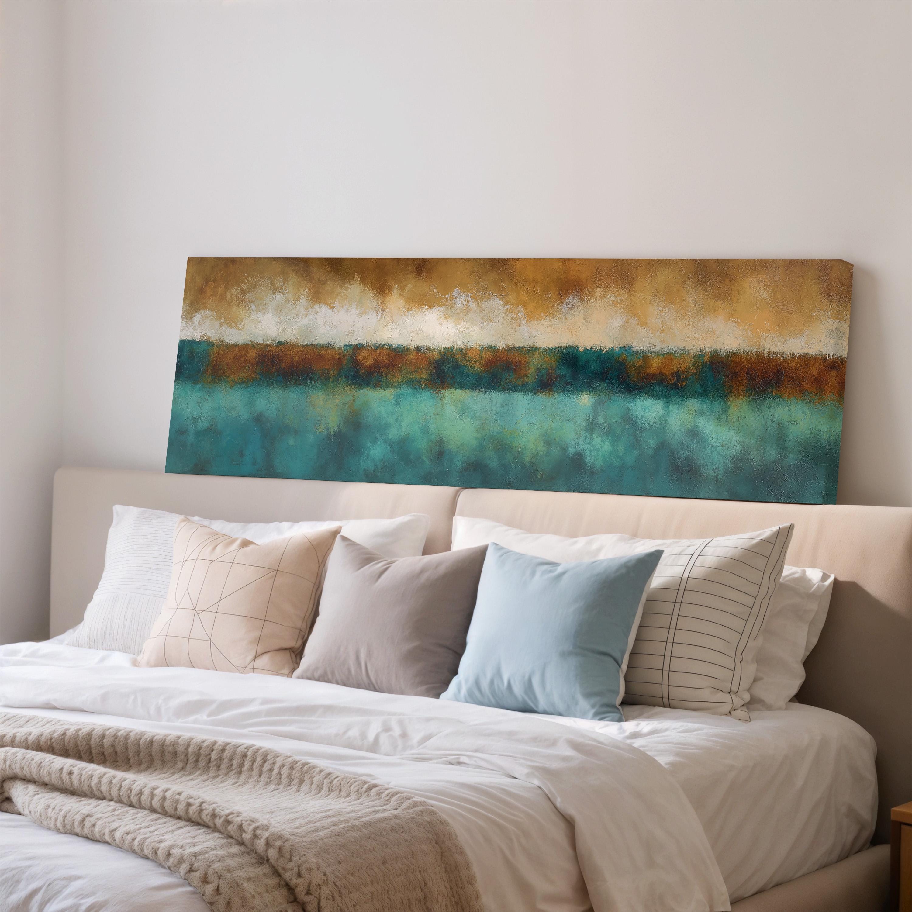 a bedroom with a large bed covered in white sheets and pillows. Above the bed, there is a large painting or artwork depicting a landscape with a blue sky and green grass.