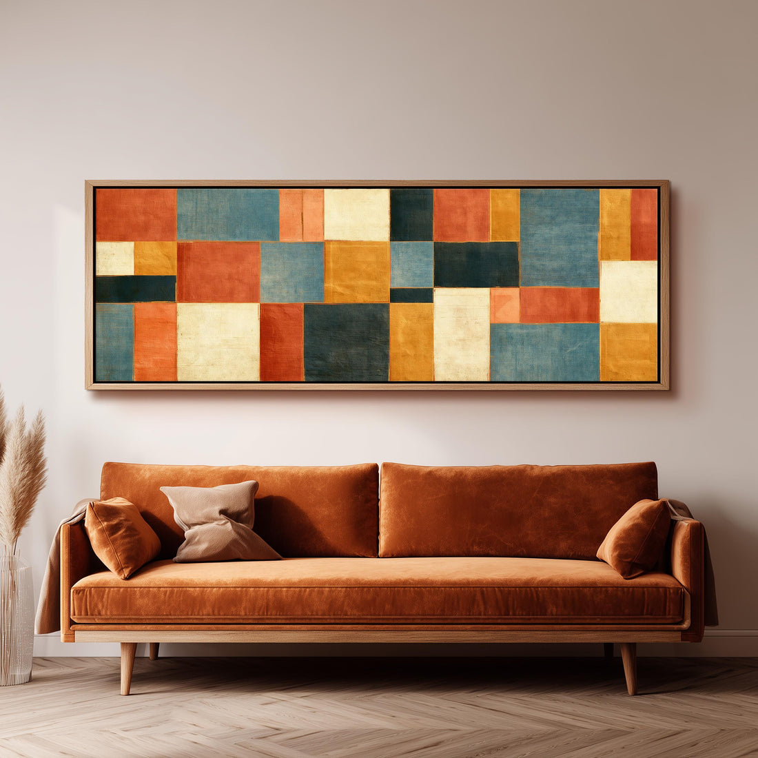 Rust, gold, navy and cream quilt blocks long horizontal canvas print above a sofa in a living room
