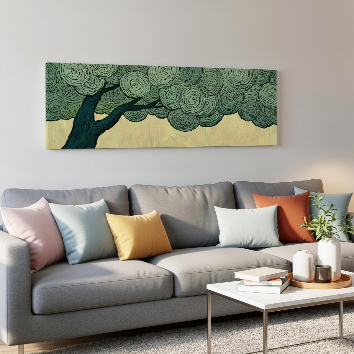 Tree with a swirling green canopy panoramic canvas print above a grey sofa in a living room