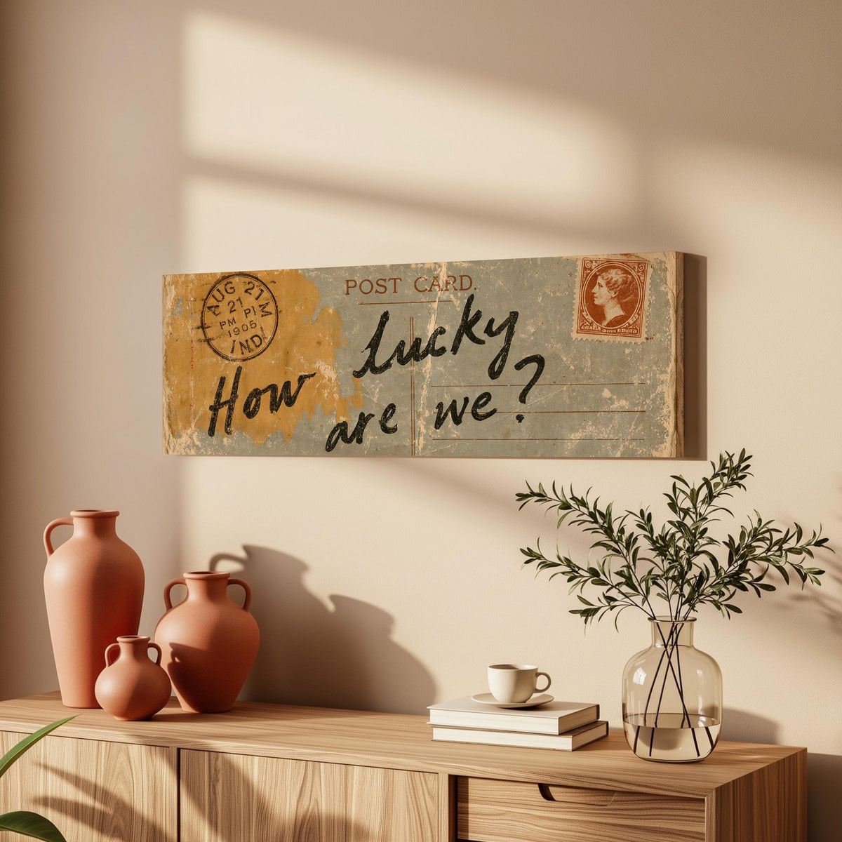 Vintage postcard saying how lucky are we long horizontal canvas print above a wooden sideboard