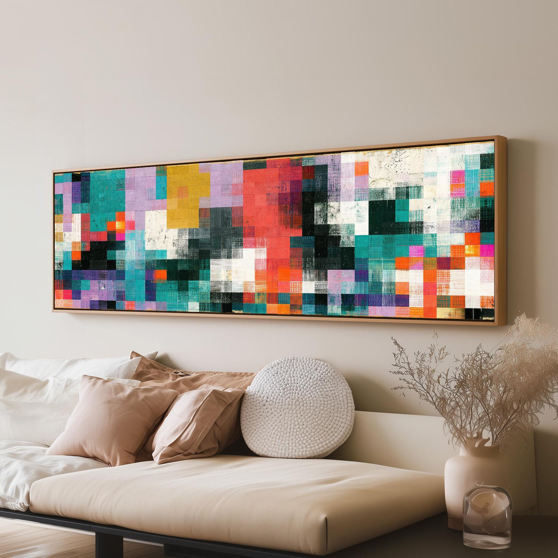 Teal and coral patchwork color blocks long horizontal canvas print above a sofa in a living room