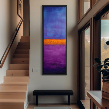 a modern hallway with a large, colorful abstract painting hanging on the wall. The painting has a vibrant mix of blue, purple, and orange colors, creating a striking visual focal point in the space. The hallway also includes a wooden staircase, a bench, and a potted plant, contributing to the overall aesthetic and design of the room.