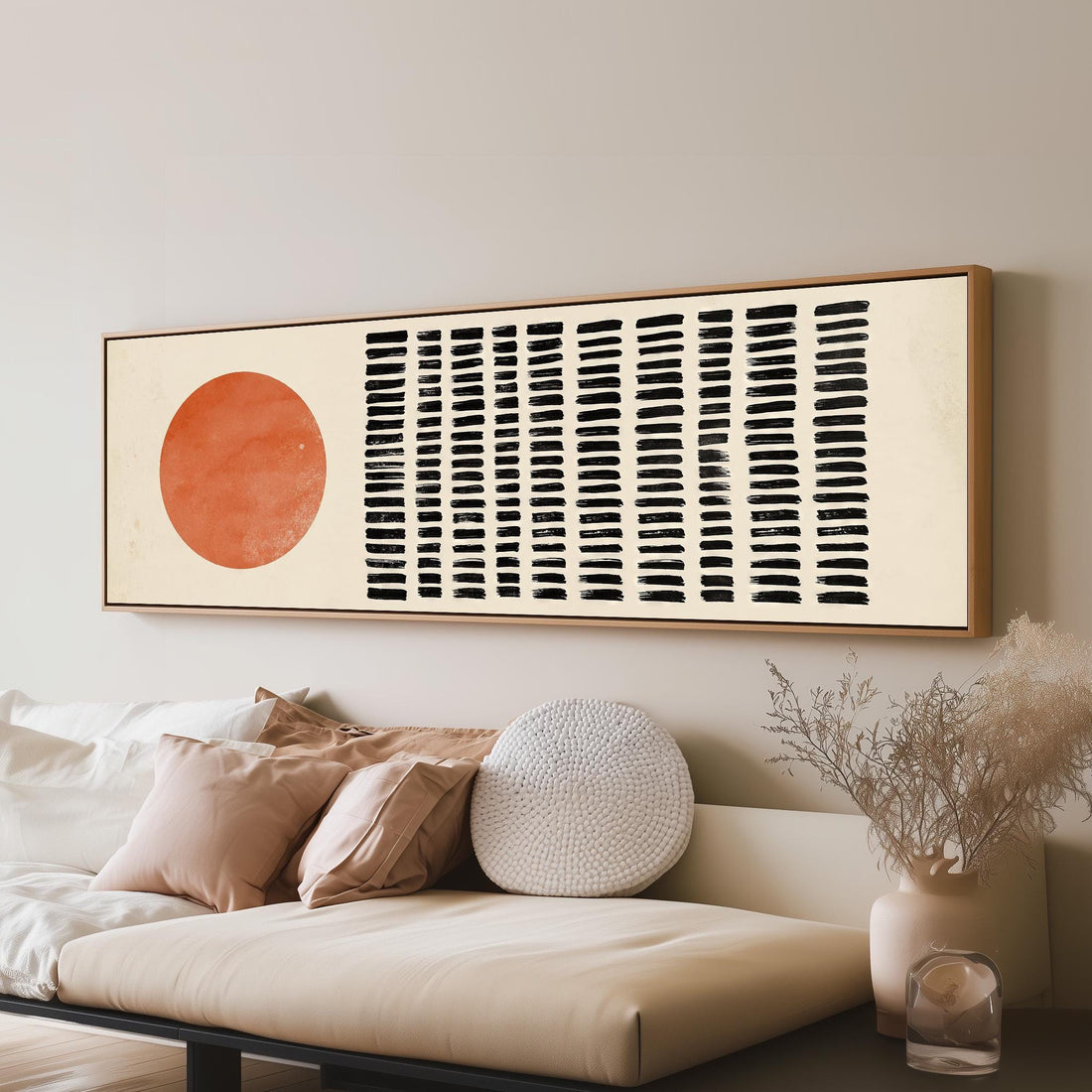 Orange sun beside rows of black dashes long horizontal canvas print above a sofa in a living room