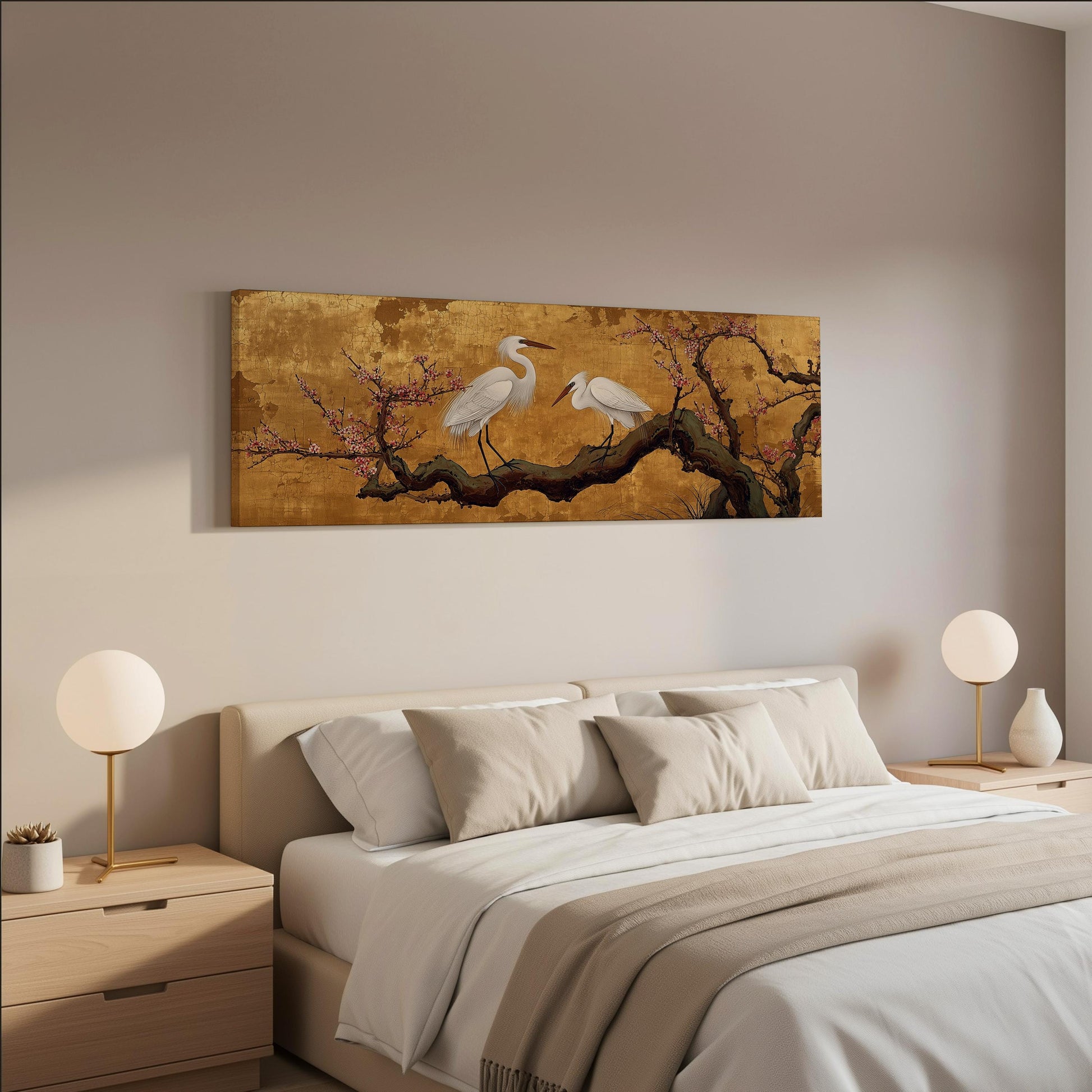 a serene bedroom scene with a large bed, two nightstands with lamps, and a painting of two white birds perched on a branch with pink flowers.
