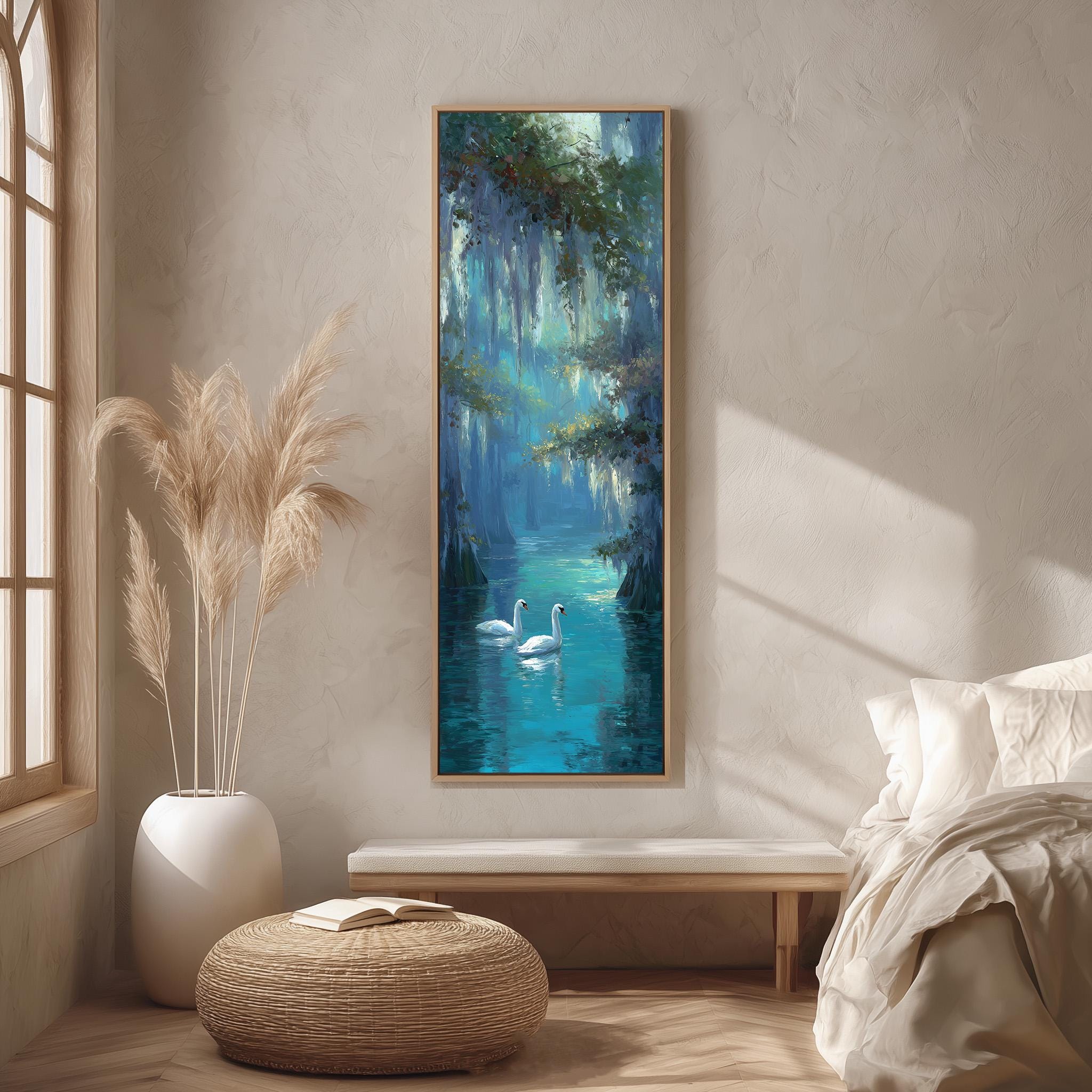 a serene indoor setting with a large painting of swans swimming in a tranquil blue-green body of water hanging on the wall. The painting is framed in a wooden frame and is the focal point of the room. The room features a bed, a wicker ottoman, and a potted plant, creating a cozy and inviting atmosphere.