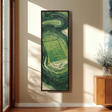 Aerial soccer field surrounded by swirling green long vertical canvas print in a sunlit living space