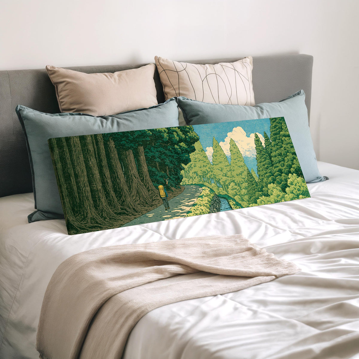 Hiker on a forest trail wide panoramic canvas print laid on a bed to show its size