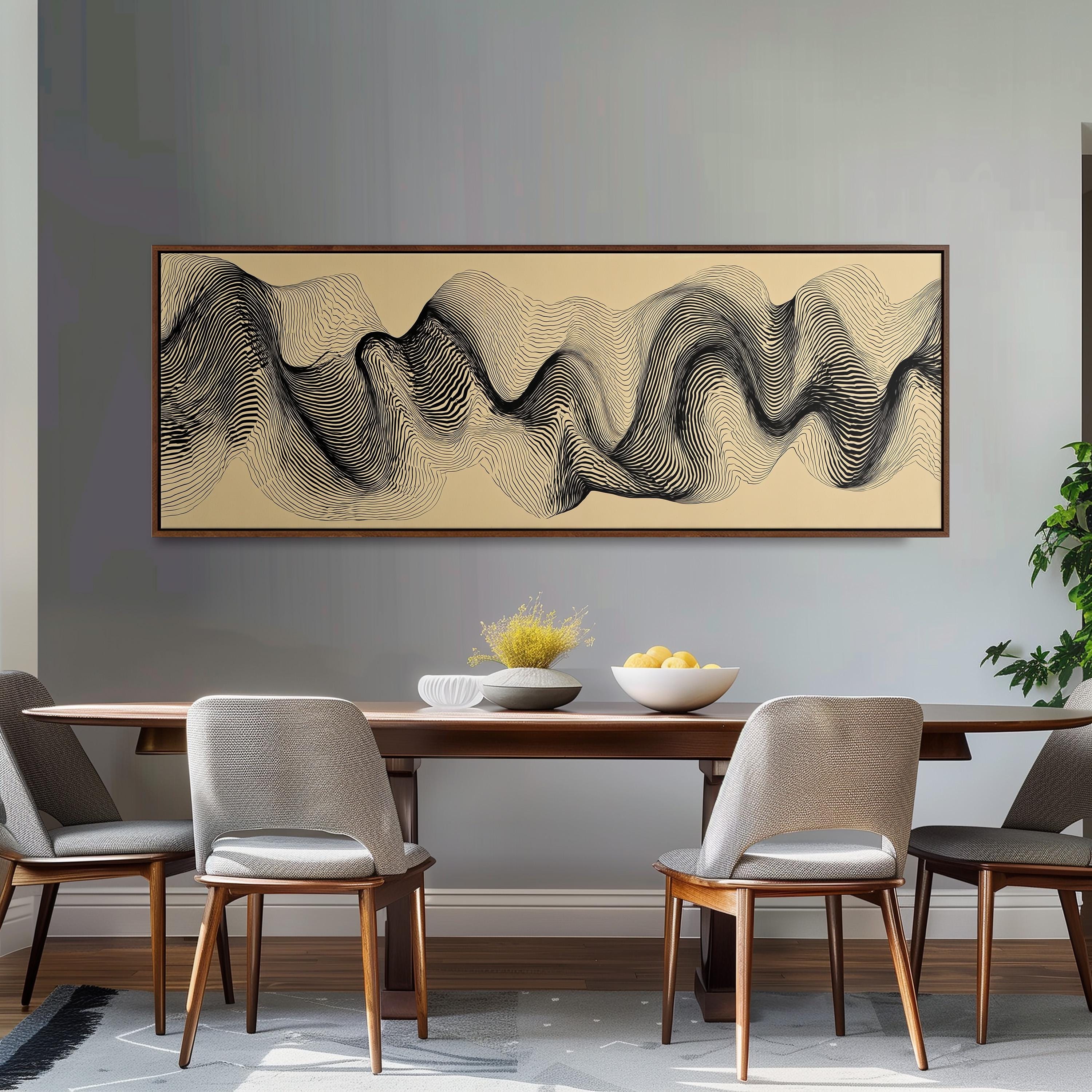 a modern dining room with a wooden table and four gray chairs. Above the table, there is a large abstract painting with a wave-like pattern in black and white. The table is set with a bowl of fruit and a vase of flowers, creating a visually appealing and inviting atmosphere.