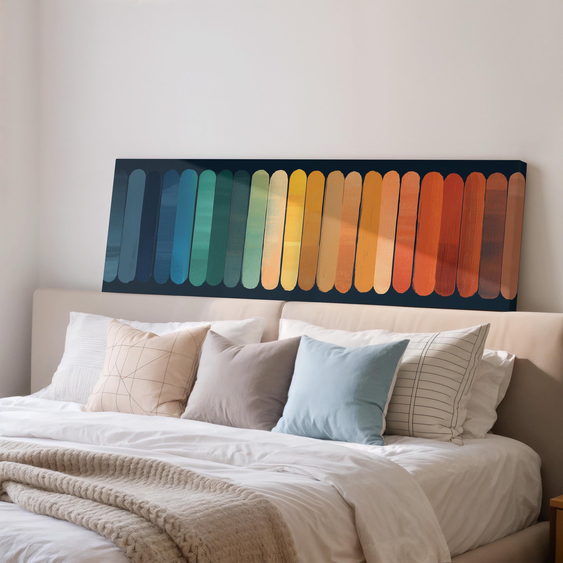 a large bed with a colorful abstract painting hanging above it.