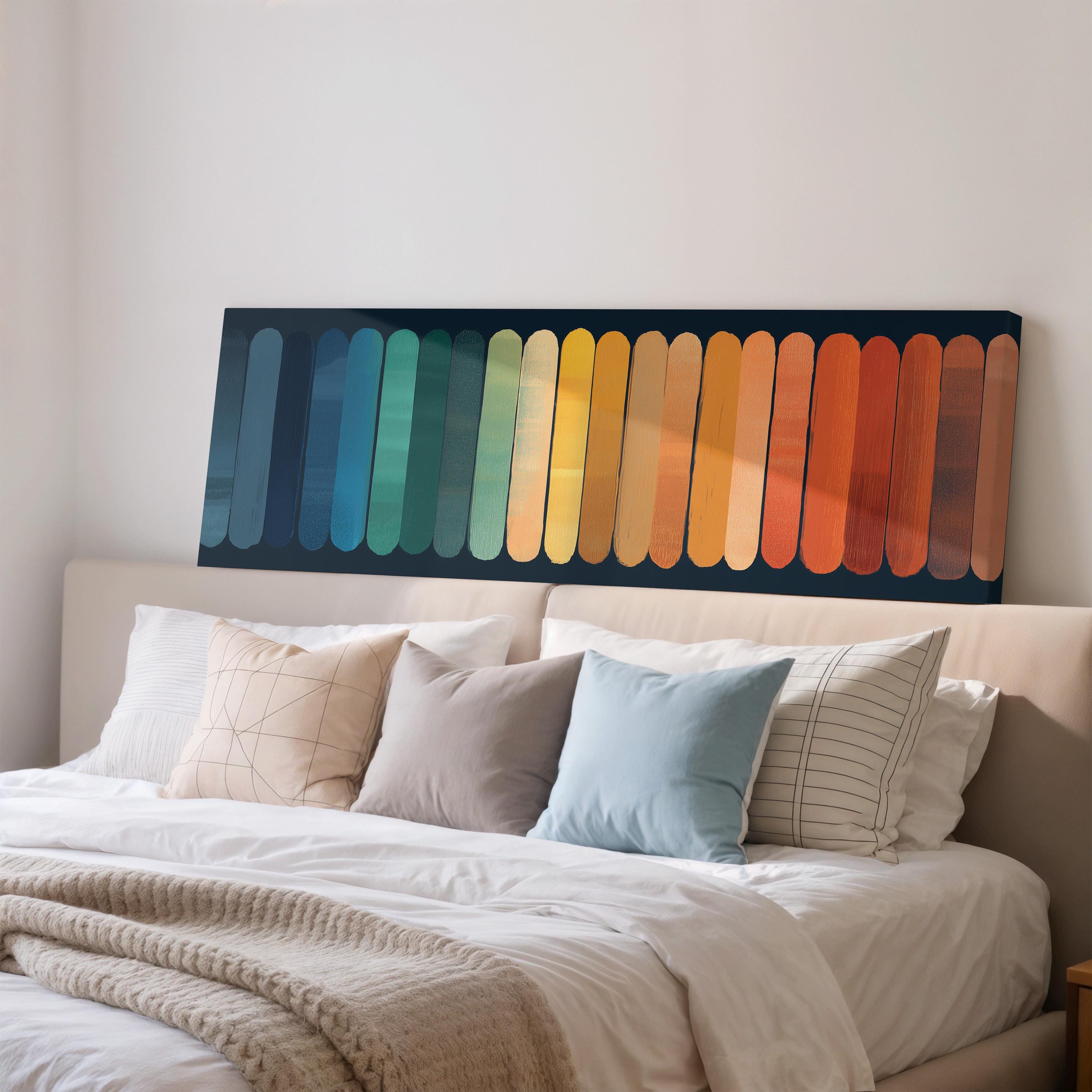 a large bed with a colorful abstract painting hanging above it.