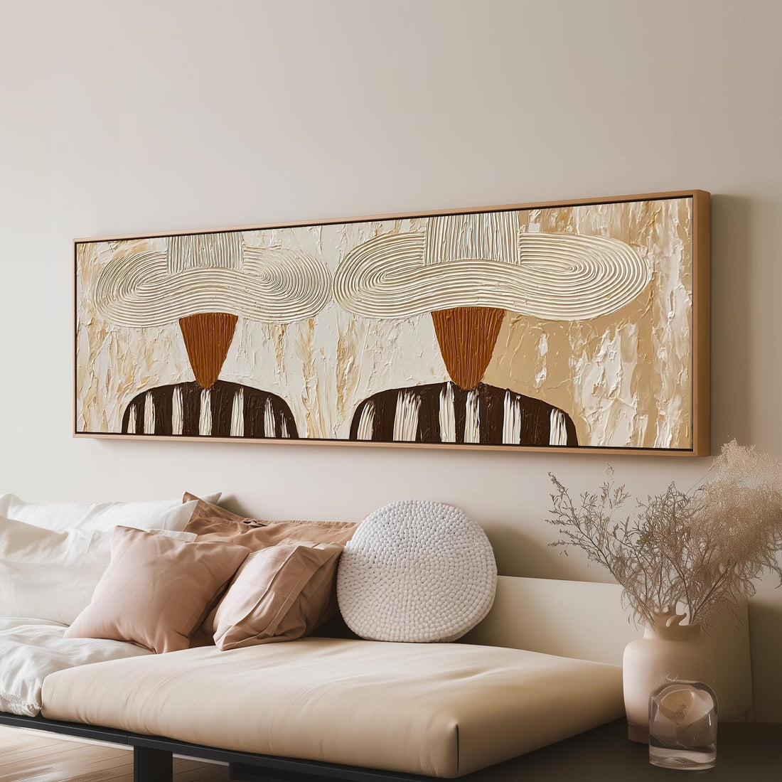 Two folk figures in wide textured hats long horizontal canvas print above a sofa in a living room