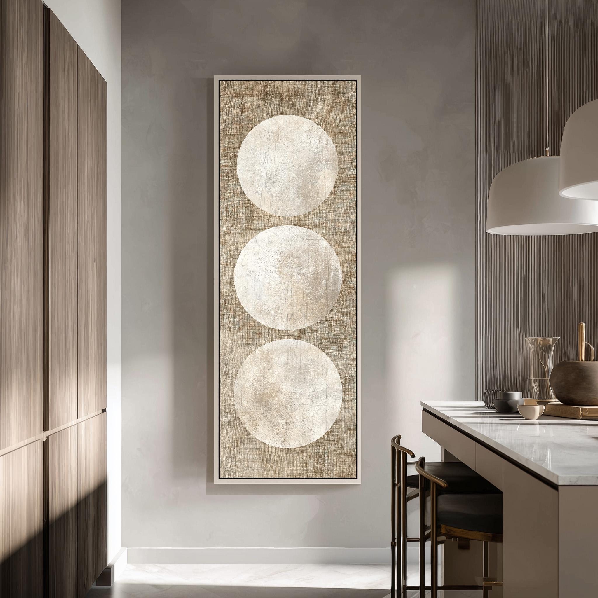 a modern kitchen with a large abstract painting hanging on the wall, depicting three circles in a minimalist design.