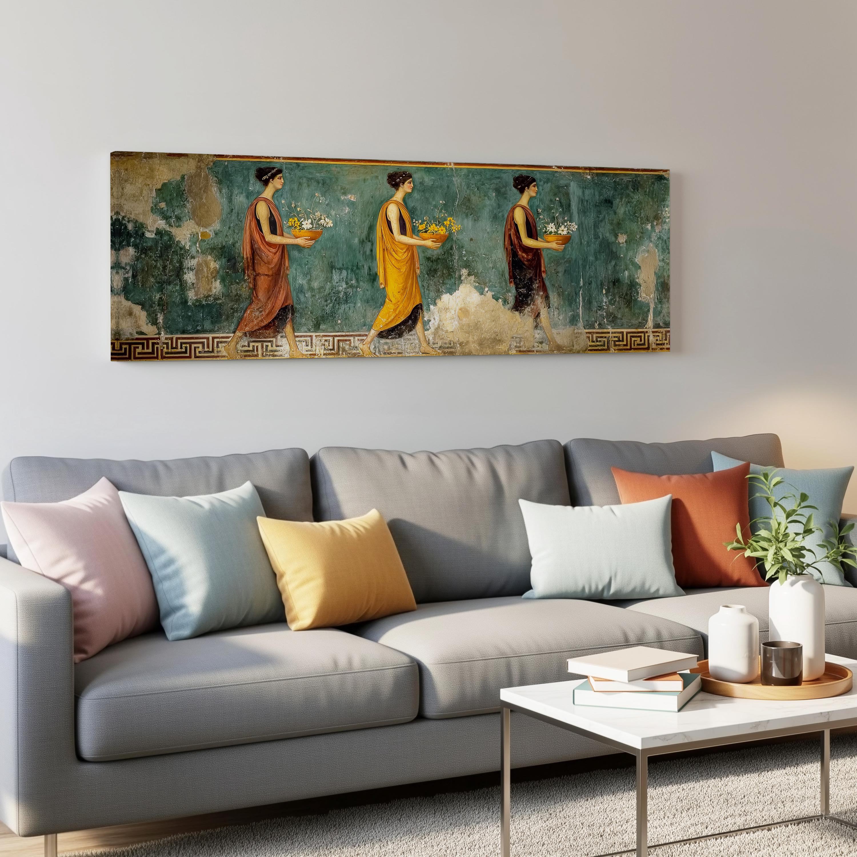 a large painting of three women in colorful dresses, displayed on a wall above a gray couch with colorful throw pillows.