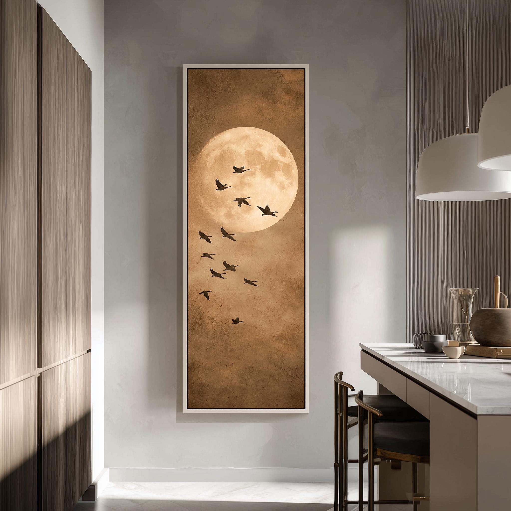 a large framed painting of a flock of birds flying against a backdrop of a large, full moon.