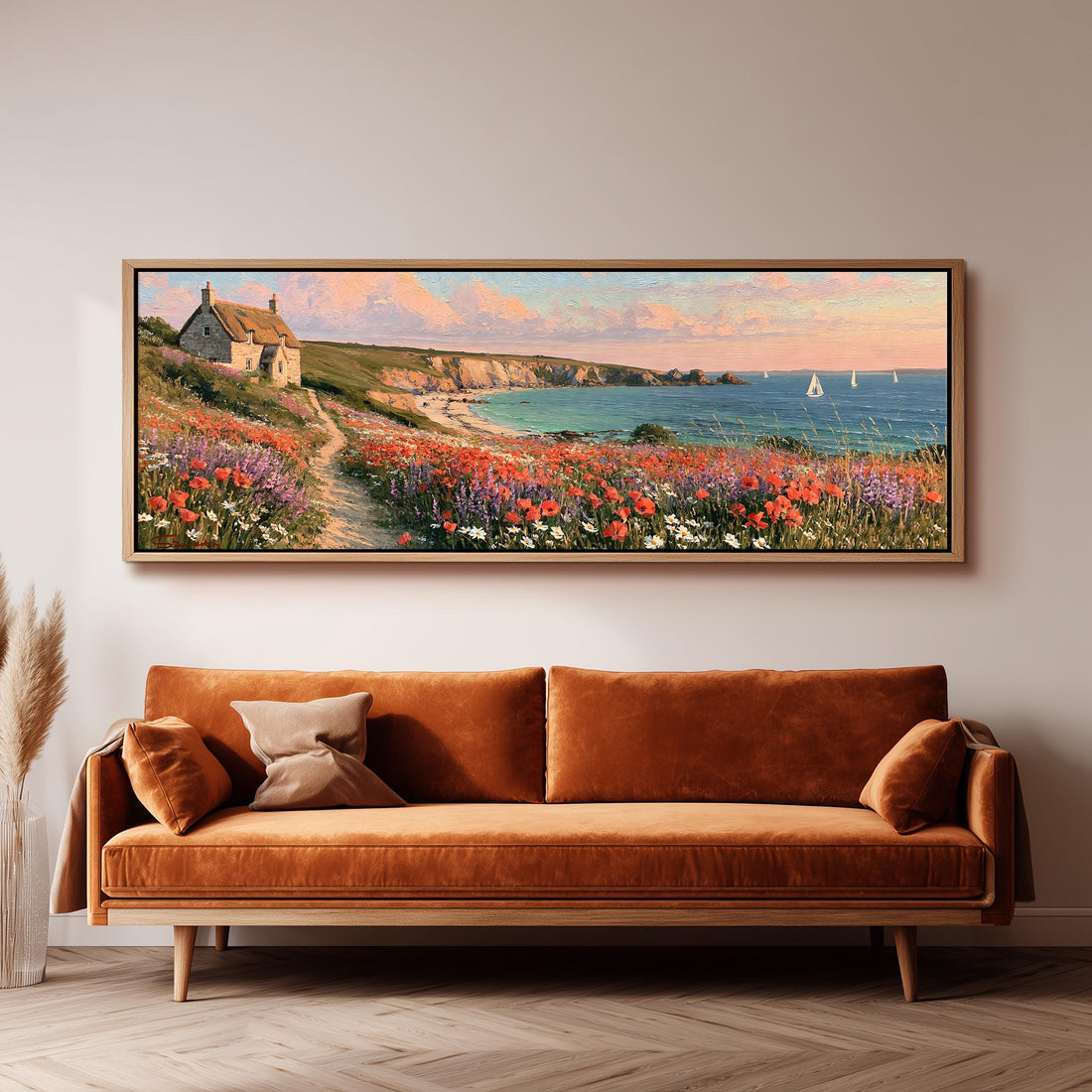 Seaside cottage above a poppy-covered cliff path long horizontal canvas print above a sofa in a living room