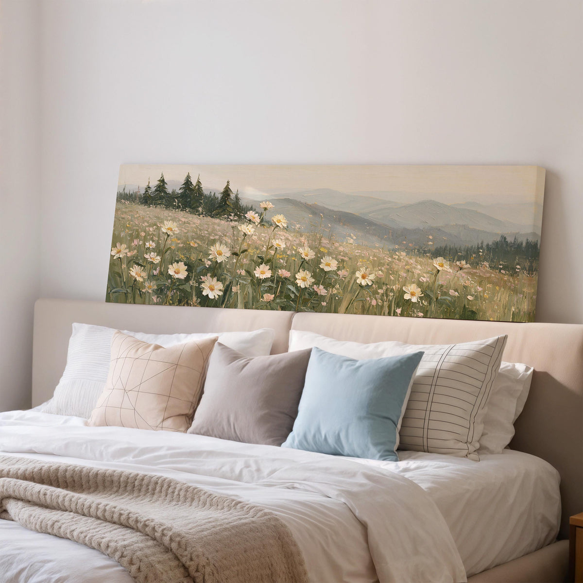 Daisy hillside below blue mountains wide panoramic canvas print above a bed in a bedroom