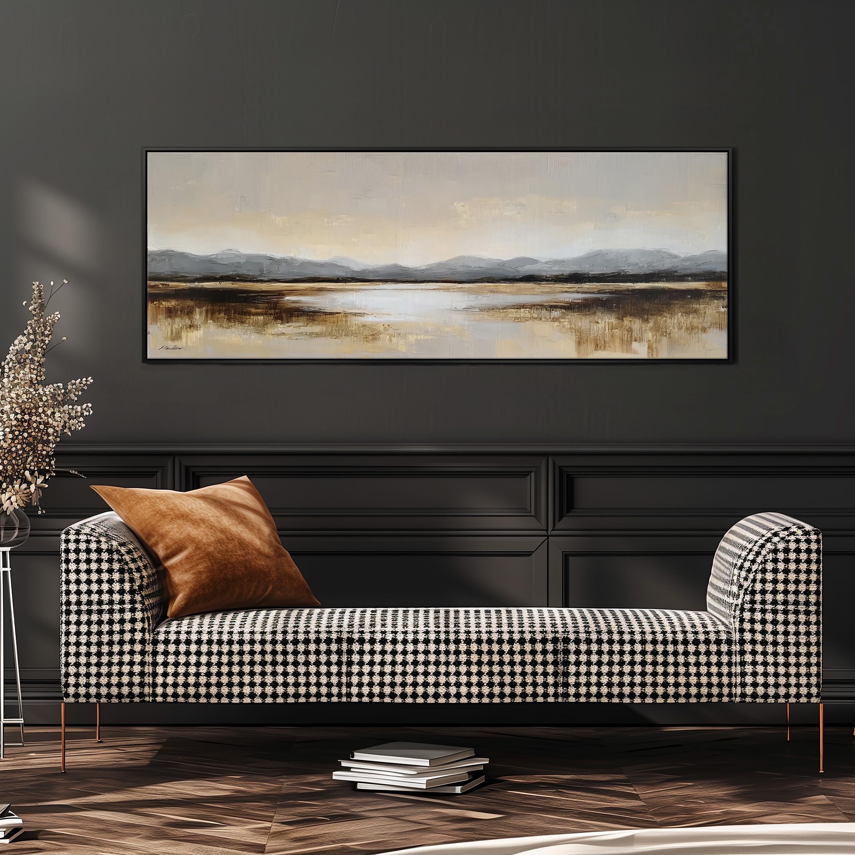 a large landscape painting hanging on a dark wall above a black and white checkered sofa with a brown throw pillow.