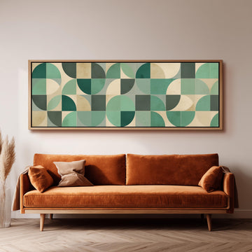 a large, rectangular abstract artwork hanging on a wall above a brown sofa with orange cushions.