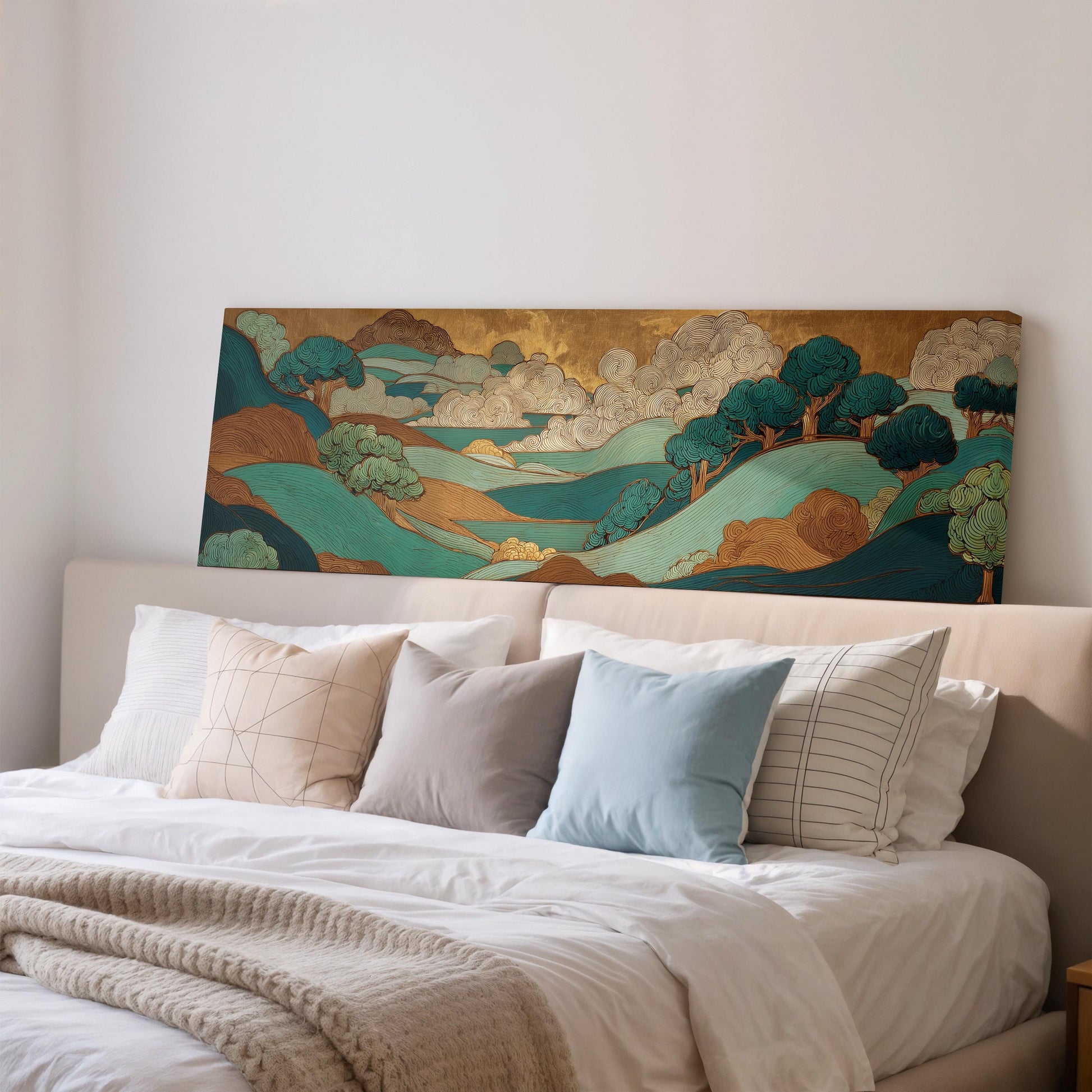 a large, colorful landscape painting hanging on a wall above a bed with white pillows and a gray blanket.