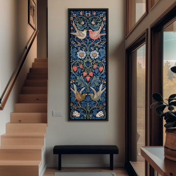 a hallway with a large, colorful tapestry hanging on the wall, depicting a floral design with birds and flowers. The hallway has a wooden staircase and a bench, and there is a plant in a pot on the right side of the image.