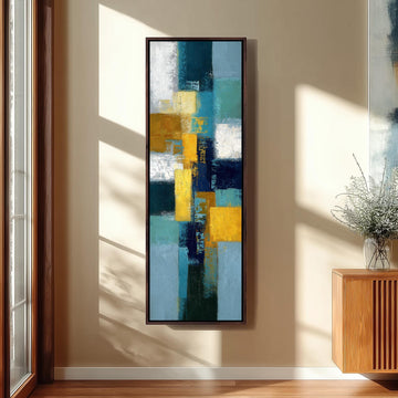 a large abstract painting hanging on a wall in a room with a wooden floor and a window.