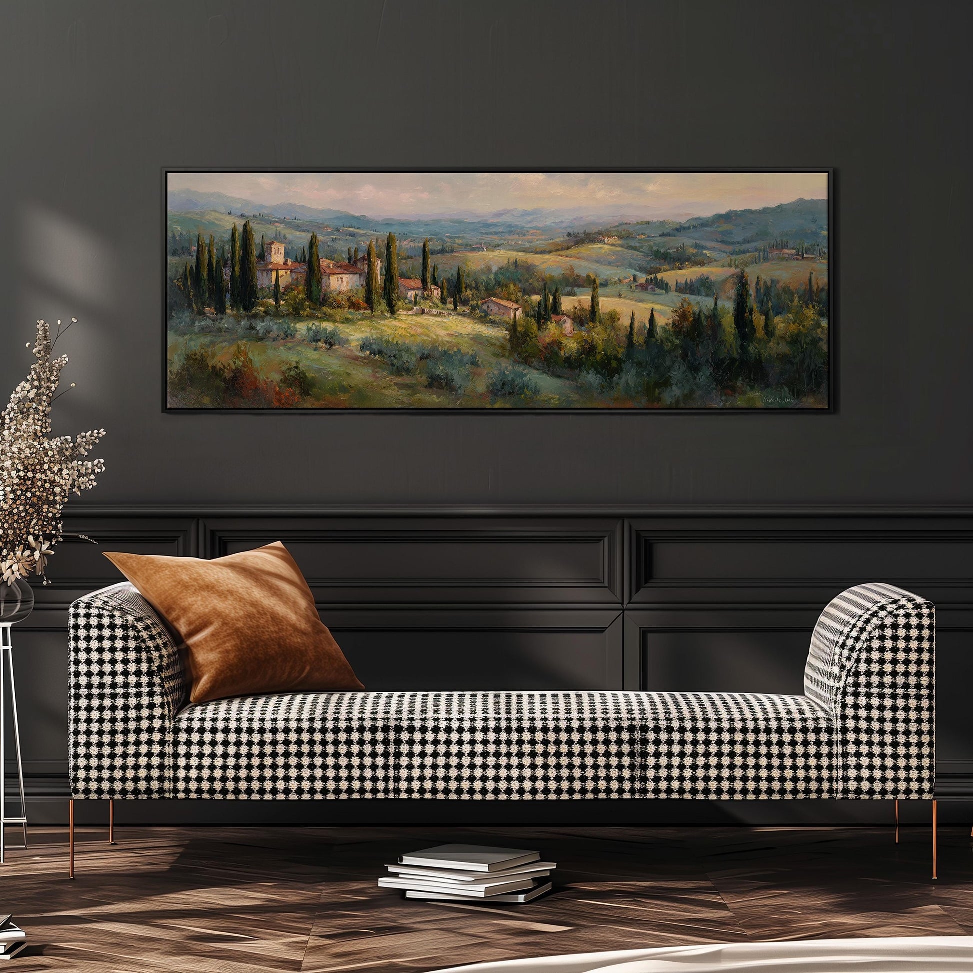 a large painting of a countryside landscape hanging on a wall above a black and white checkered sofa with a brown throw pillow.
