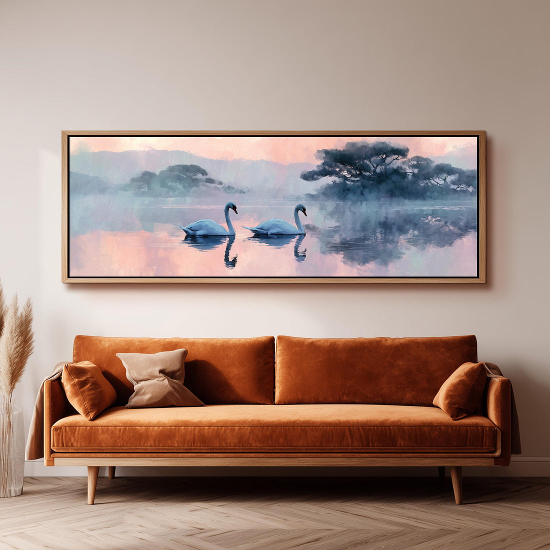 a large painting of two swans floating on a serene lake, with a warm, orange-colored sofa in the foreground.
