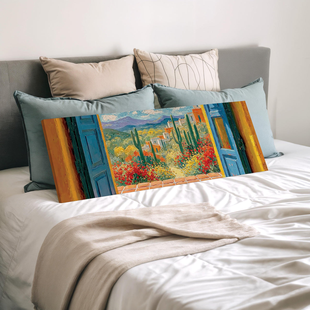 Cactus courtyard seen through blue doors wide panoramic canvas print laid on a bed to show its size