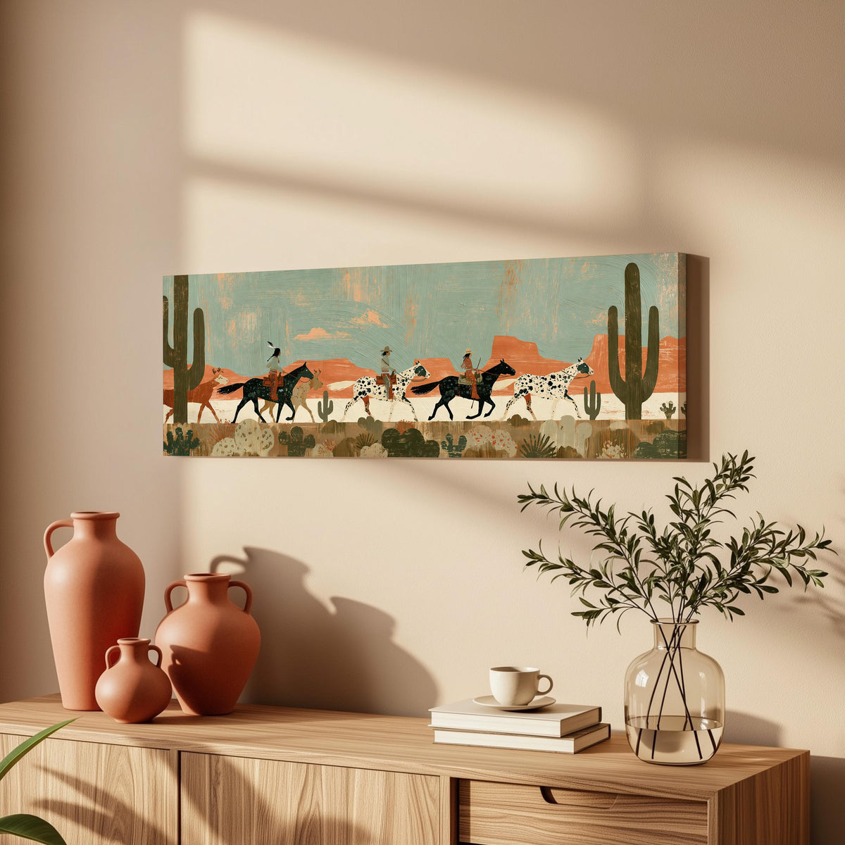 Riders on spotted horses across a red rock desert long horizontal canvas print above a wooden sideboard