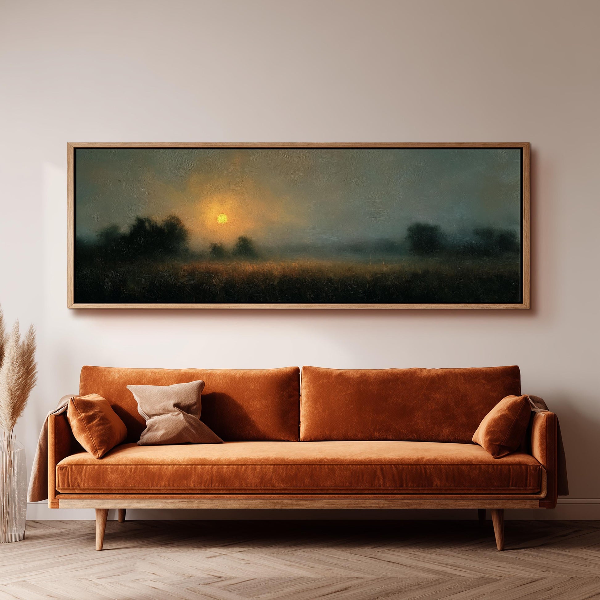 a large, rectangular painting hanging on a wall above a brown sofa with orange cushions.