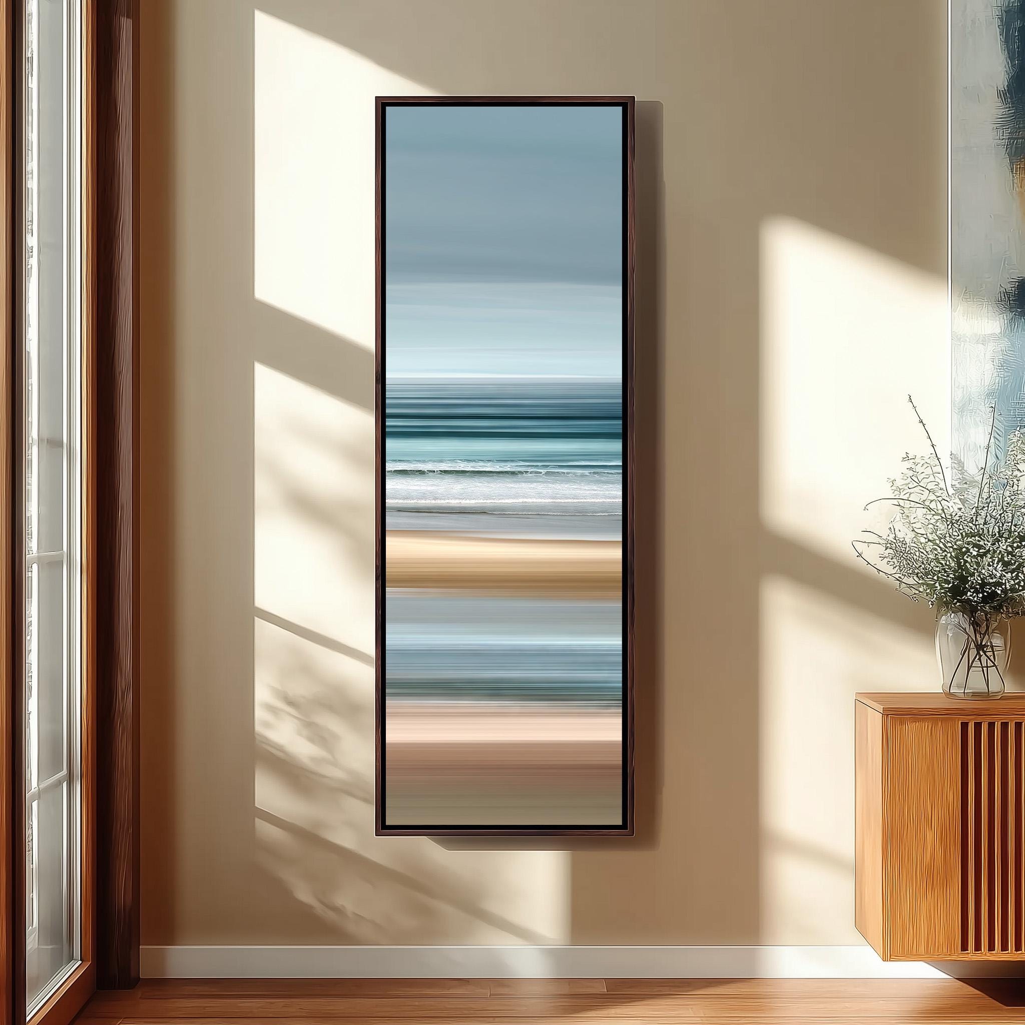 a large, rectangular painting hanging on a wall in a room with a wooden floor and a window.