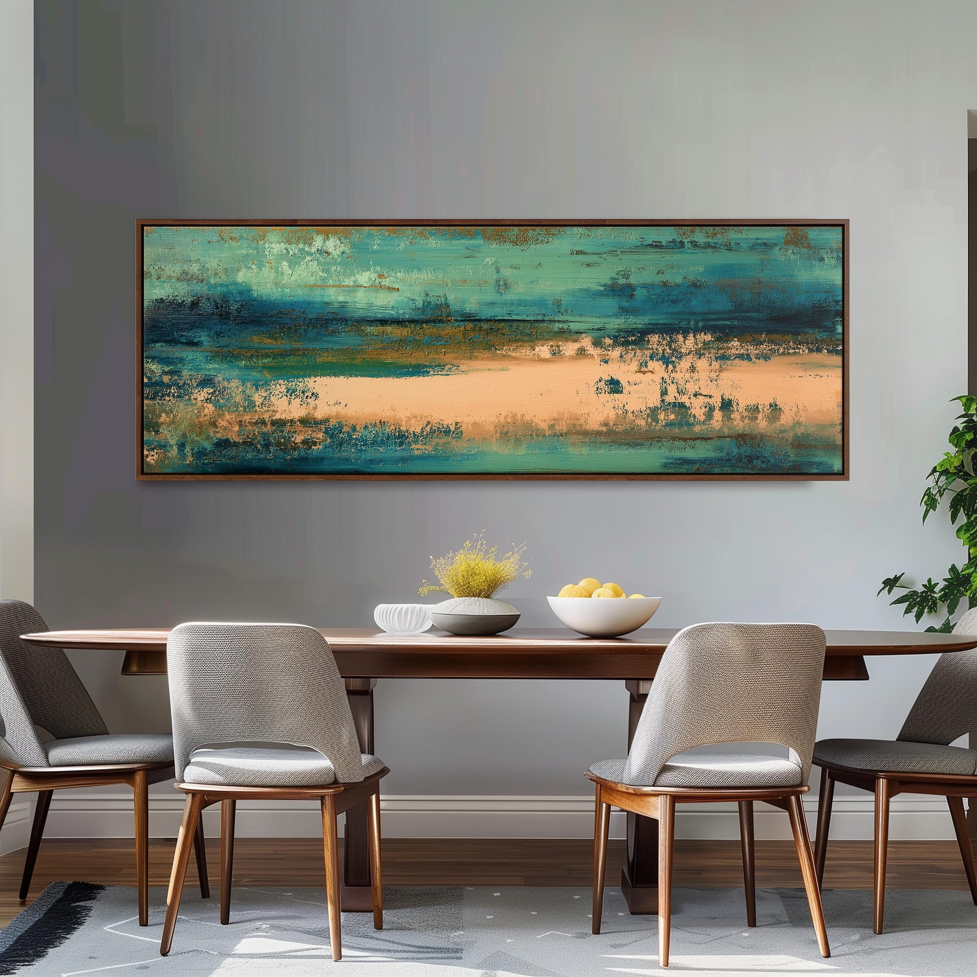 a dining room with a large, colorful abstract painting hanging on the wall above a wooden dining table. The table is set with a bowl of fruit and a vase of flowers, creating a welcoming and inviting atmosphere. The room is furnished with four chairs, two on each side of the table, and a potted plant is placed on the right side of the room.