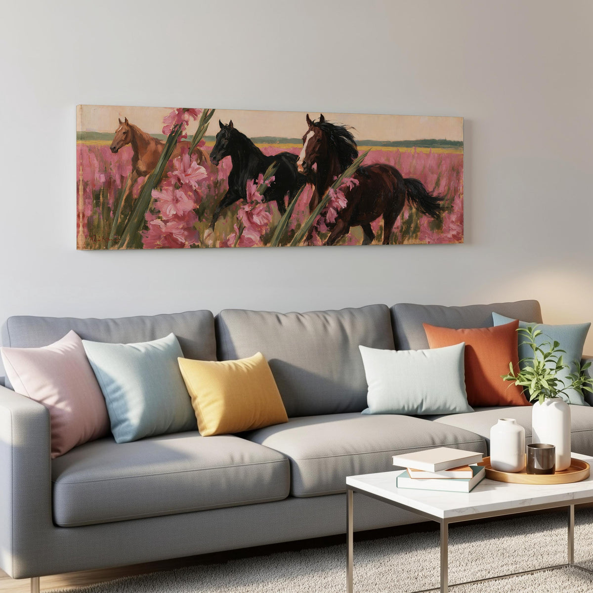 Horses running through pink gladiolus panoramic canvas print above a grey sofa in a living room