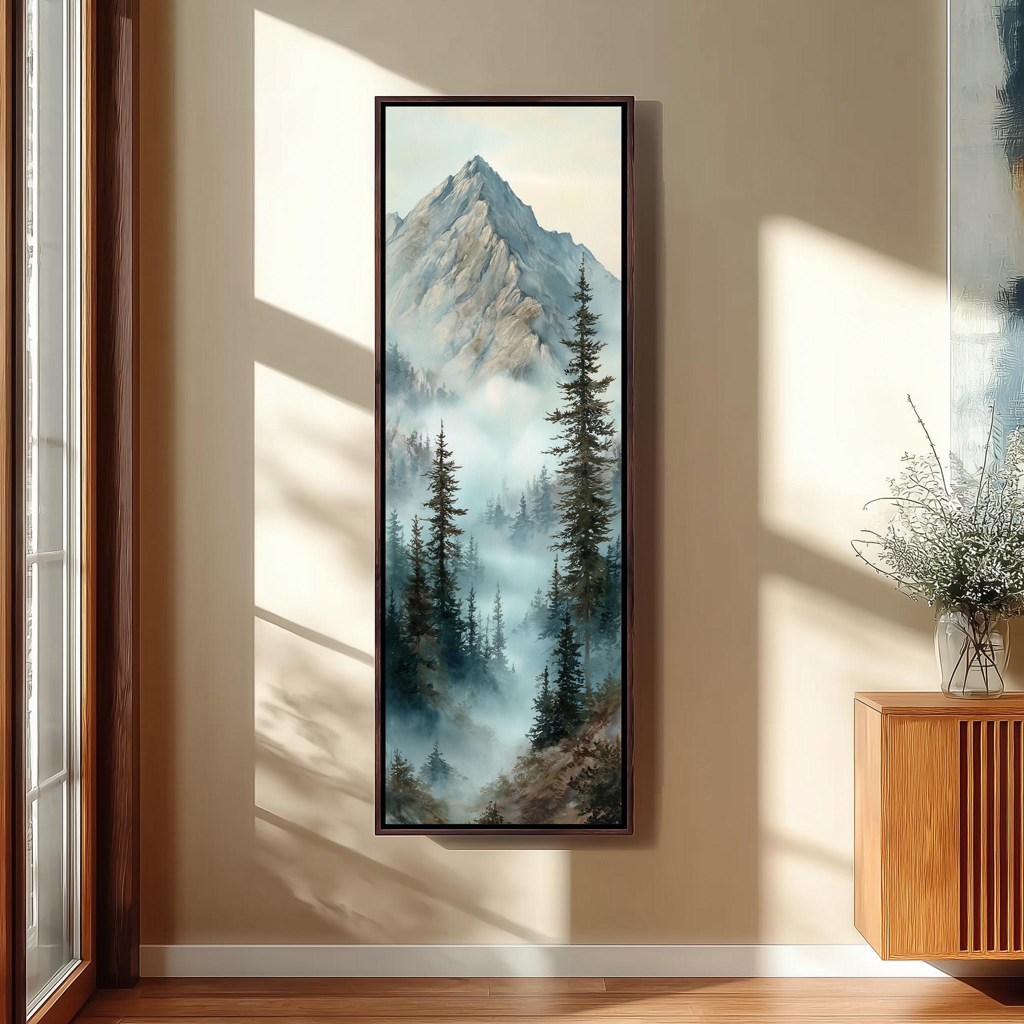 a large framed painting of a mountain landscape with pine trees and a misty, hazy atmosphere. The painting is hanging on a wall in a room with a wooden floor and a window.
