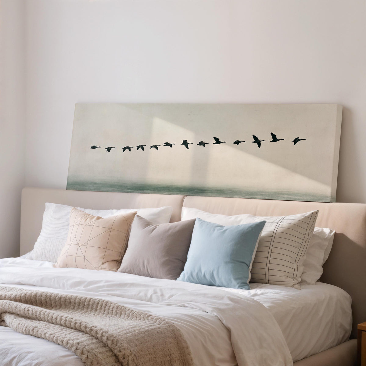 Geese flying over still water wide panoramic canvas print above a bed in a bedroom