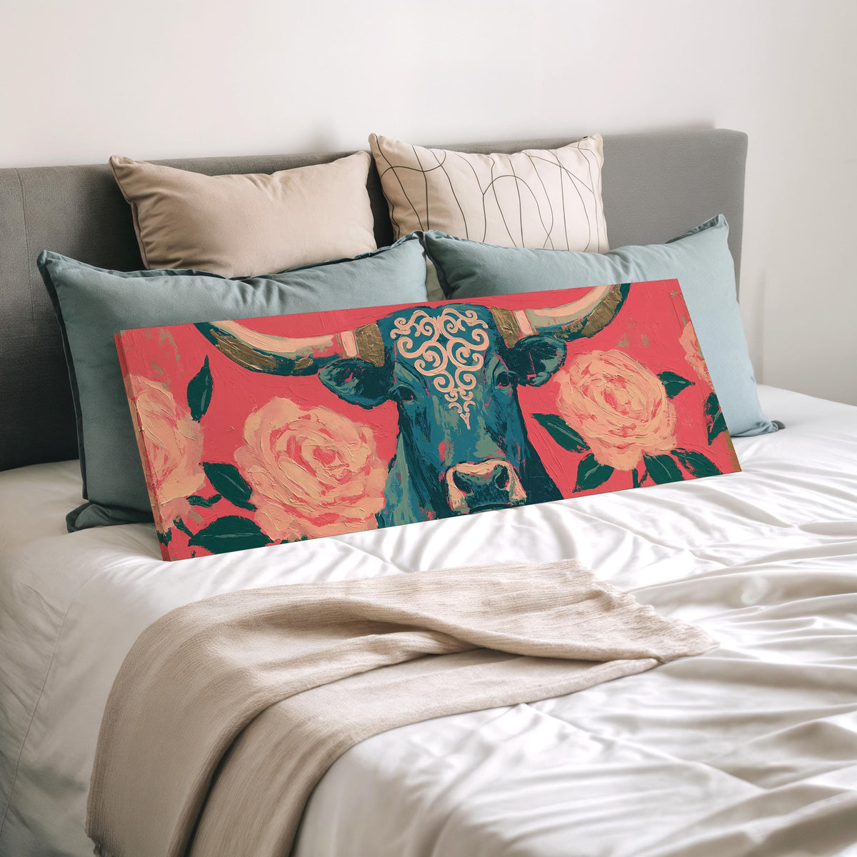 Longhorn with pink roses wide panoramic canvas print laid on a bed to show its size