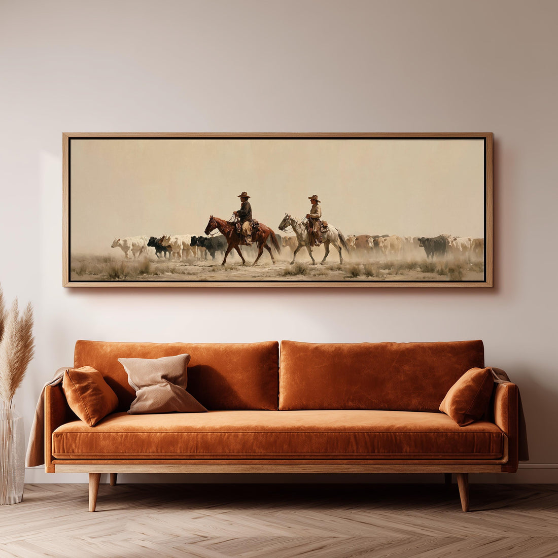 Cowboys herding cattle across a dusty plain long horizontal canvas print above a sofa in a living room