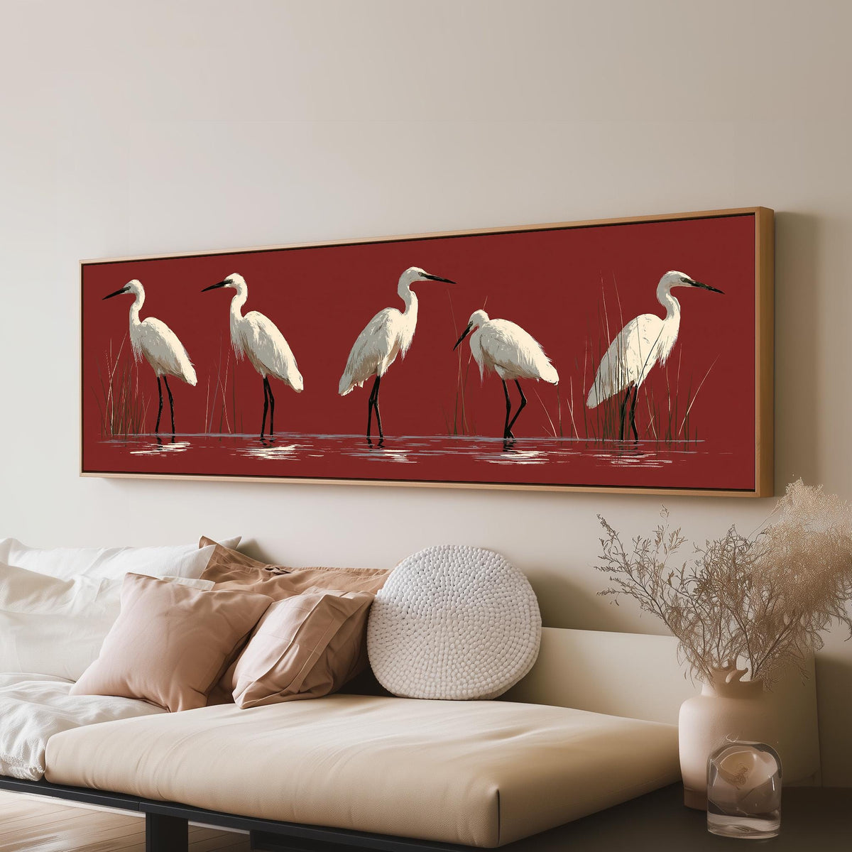White egrets wading on crimson red panoramic canvas print above a sofa in a living room