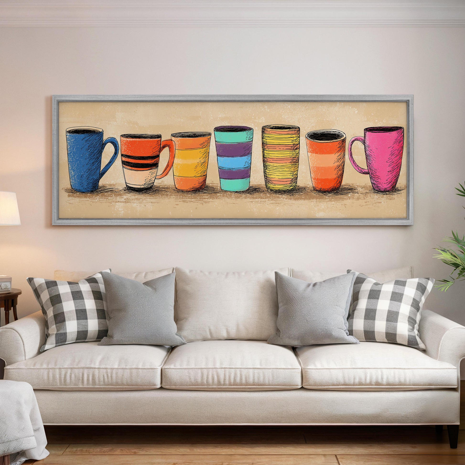 a large framed artwork depicting a row of colorful mugs on a wall above a white couch with gray and black plaid throw pillows.