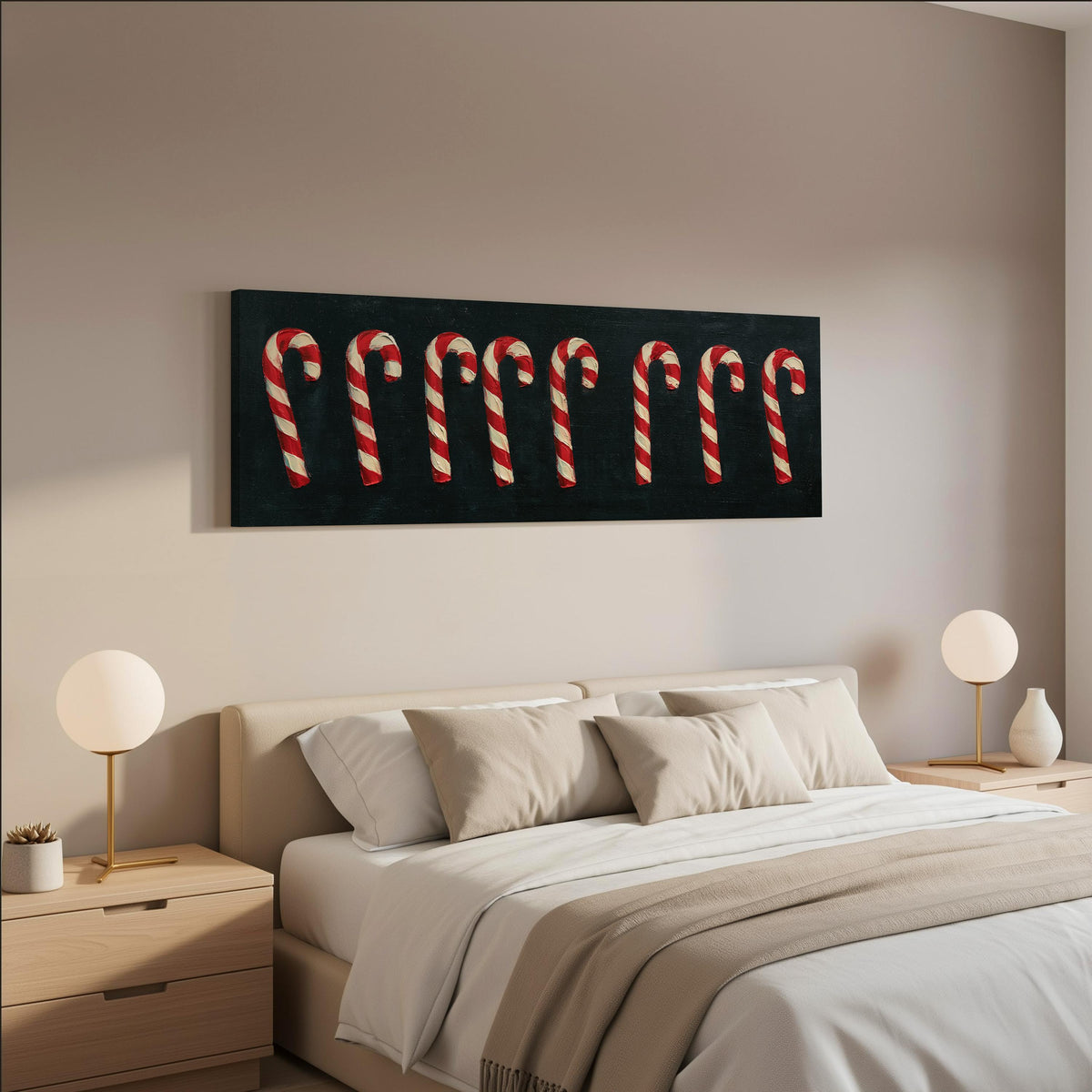 Row of candy canes on black wide panoramic canvas print above a bed in a neutral bedroom