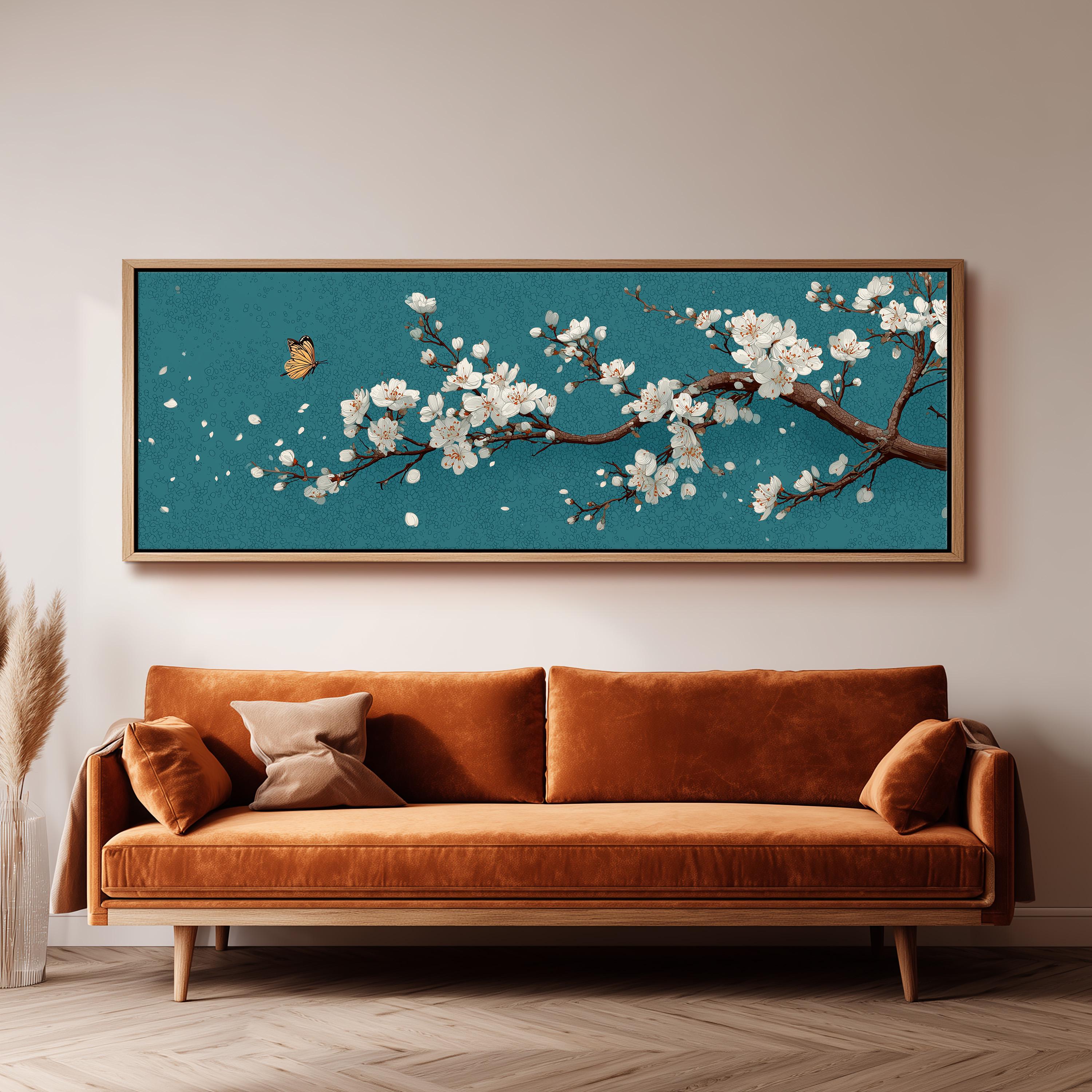 a large framed painting of a cherry blossom tree with white flowers, hanging on a wall above a brown sofa.