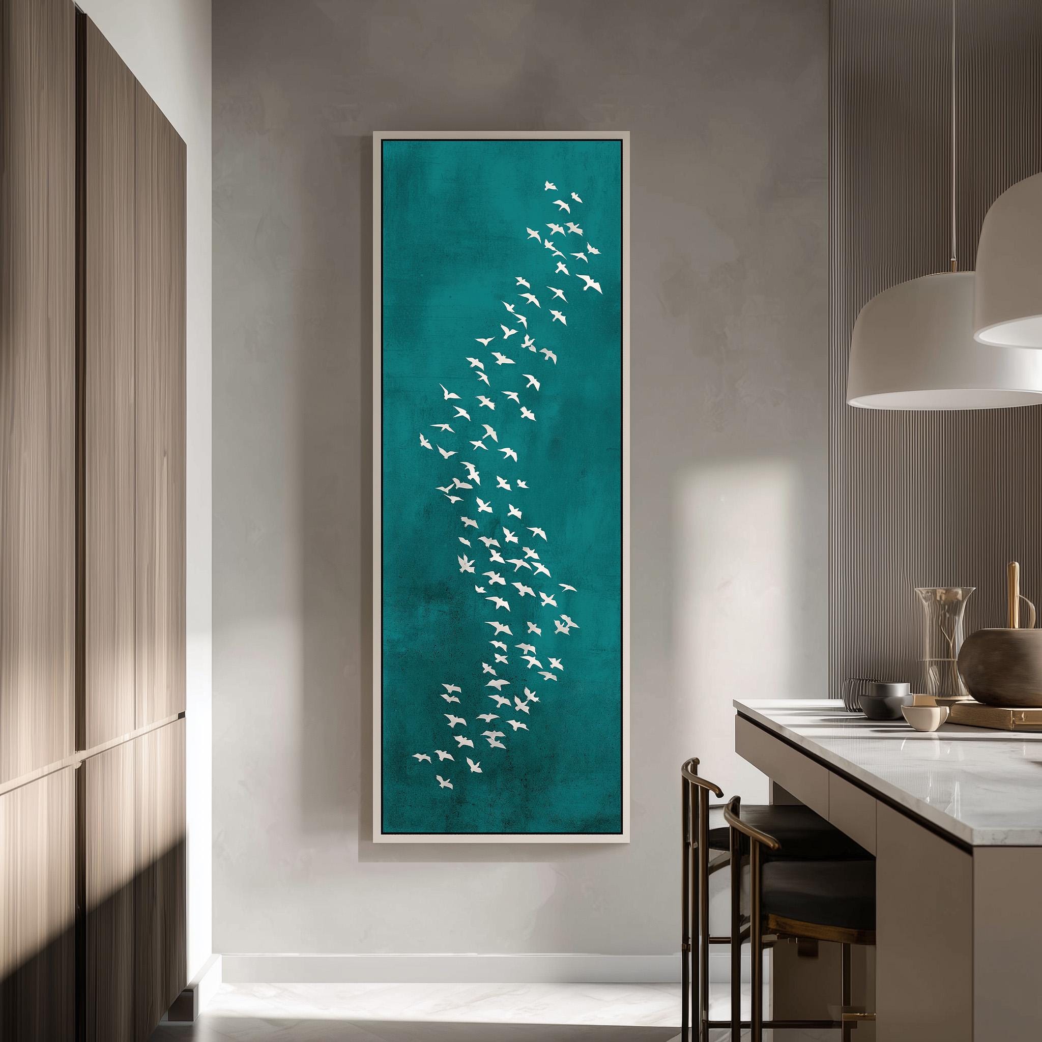 a large framed artwork depicting a flock of white birds against a teal background, hanging on a wall in a modern kitchen.