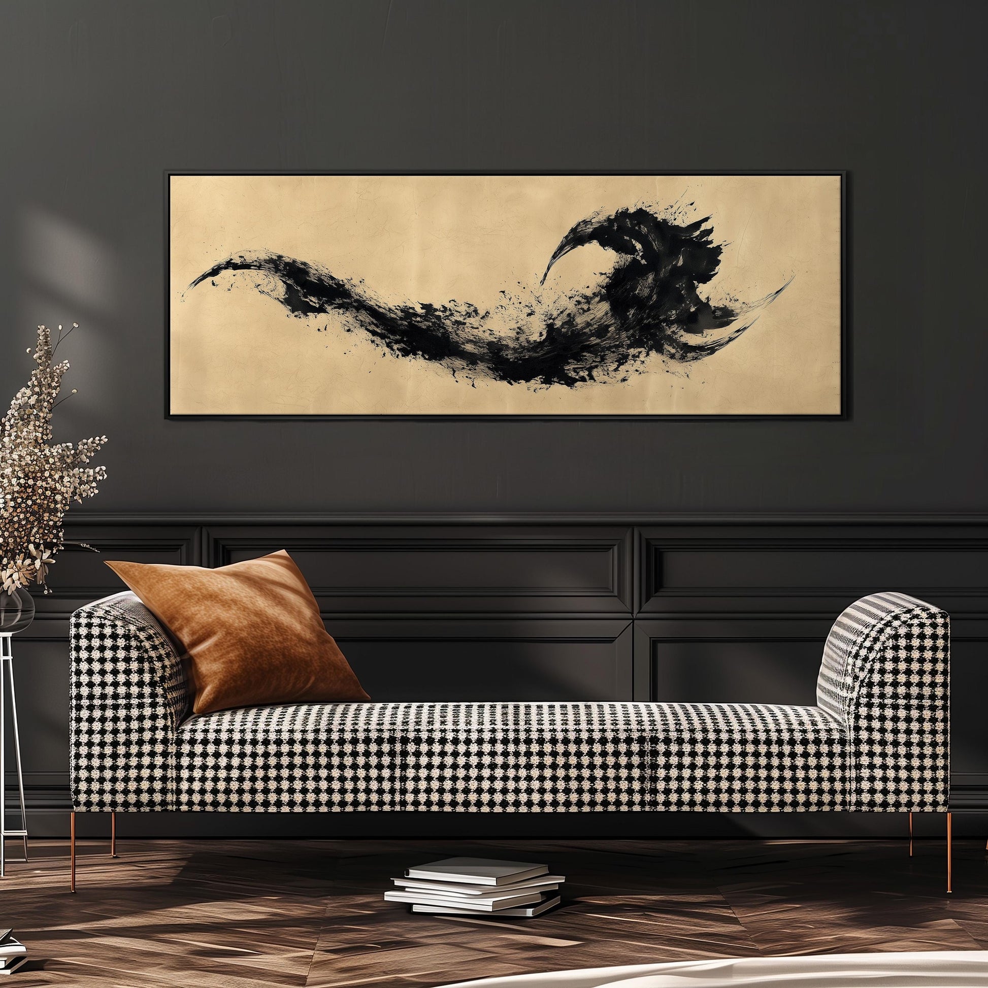 a black and white checkered sofa with a brown throw pillow, set against a dark wall with a framed abstract art piece hanging above it.
