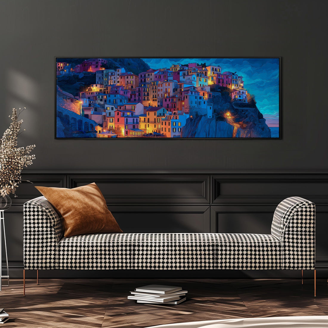 a large, colorful painting of a town on a wall, with buildings illuminated in various shades of blue, orange, and yellow. The painting is framed and hangs above a black and white checkered sofa with a brown throw pillow.
