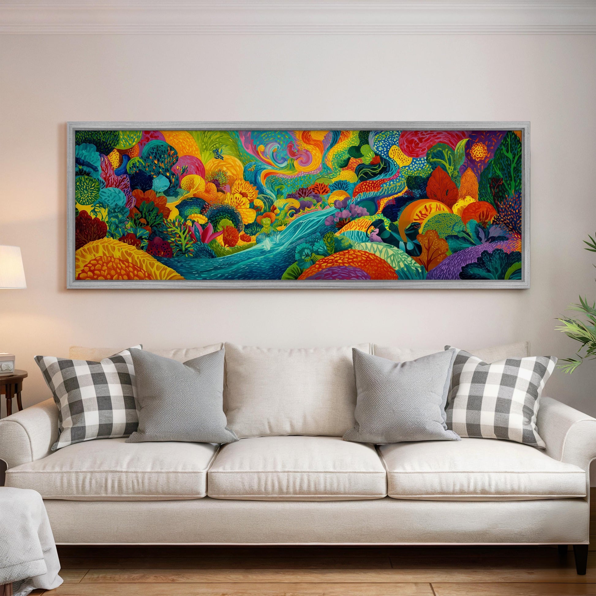 a large, colorful painting hanging on a wall above a white couch with gray and white plaid throw pillows.